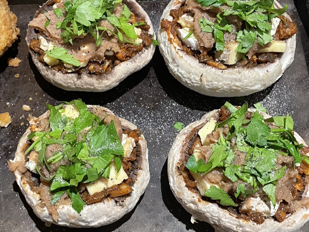 Portabella mushrooms stuffed with leftover vegan spag bol mince, herbs and vegan cheese.